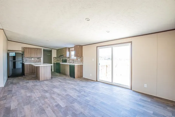 a view of wooden floor and windows in a room