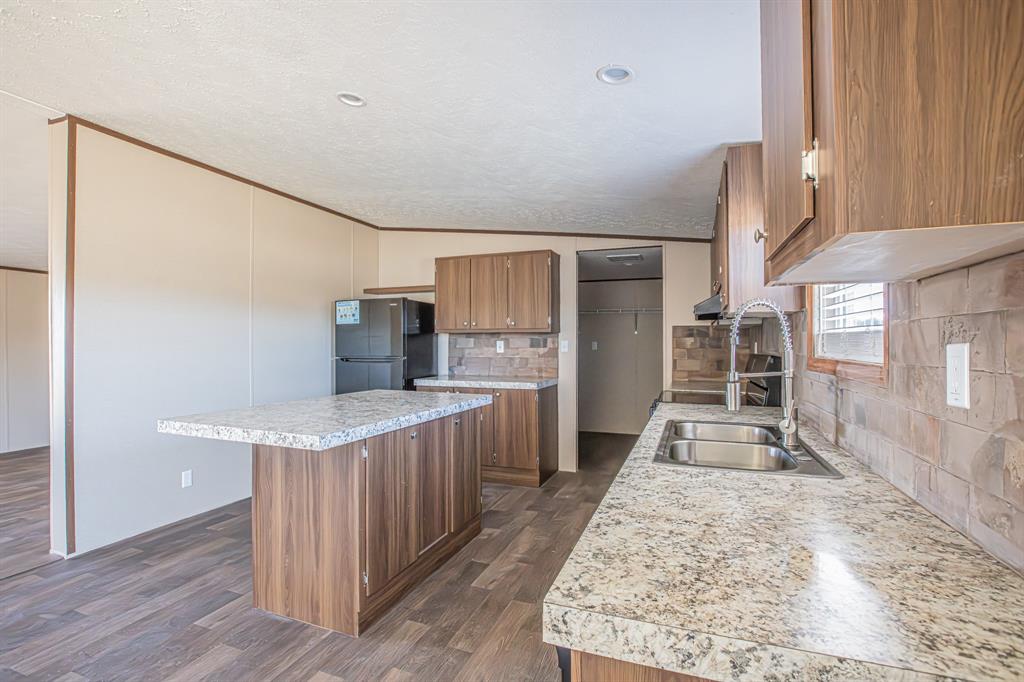 245 Lelon Lane Springtown, TX 76082 - Photo 8 of 37 a kitchen with counter top space and wooden floor