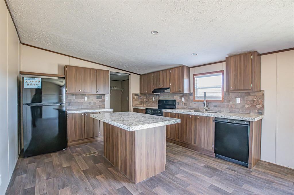245 Lelon Lane Springtown, TX 76082 - Photo 9 of 37 a kitchen with a sink stove and refrigerator