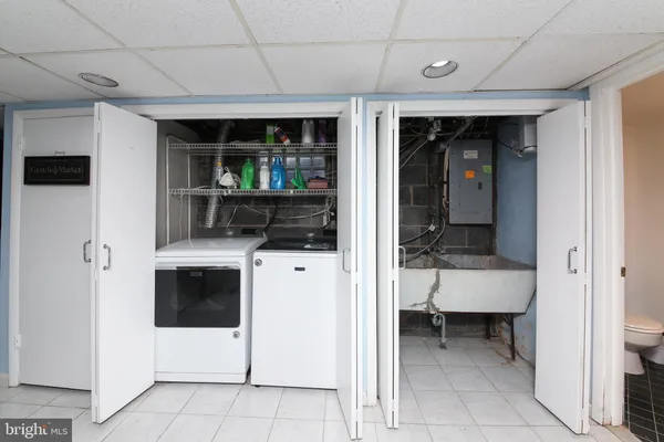 a view of kitchen with stainless steel appliances kitchen island granite countertop a refrigerator and a sink