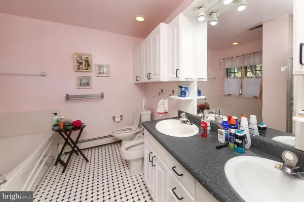 a bathroom with a sink double vanity and a mirror