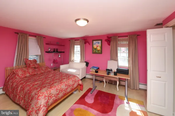 a bedroom with a bed and a desk