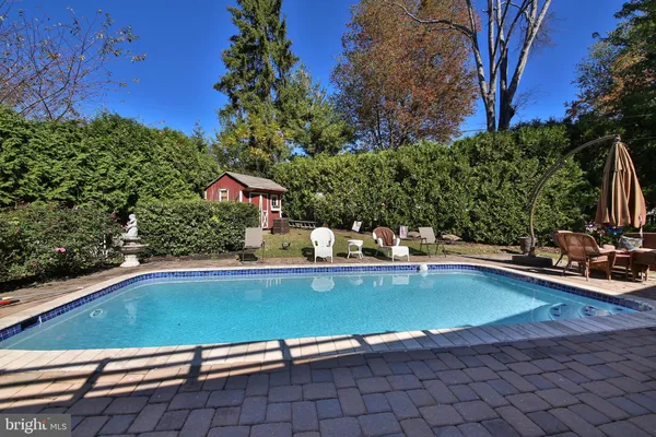 a view of swimming pool with outdoor seating and plants