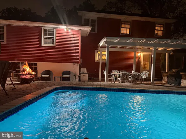 a view of a patio with dining table and chairs with plants