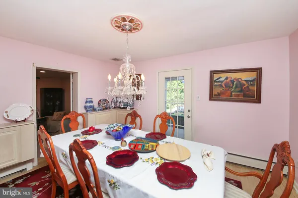 a view of a dining room with furniture and chandelier