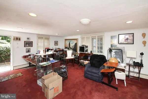 a living room with furniture kitchen view and a window