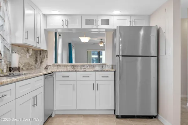 a kitchen with cabinets and stainless steel appliances