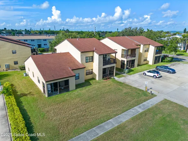 an aerial view of residential houses with outdoor space and swimming pool