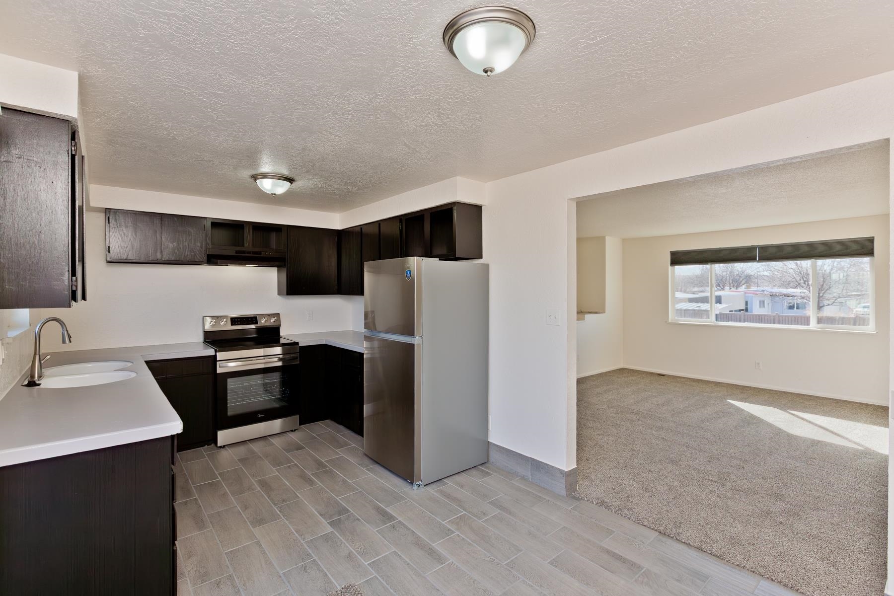 3212 D D 1/4 Road Clifton, CO 81520 - Photo 4 of 25 a kitchen with stainless steel appliances a refrigerator stove and sink