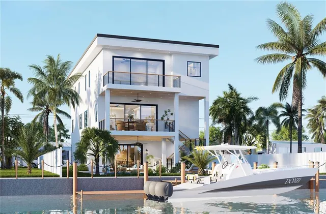 a view of a building with a yard and palm trees