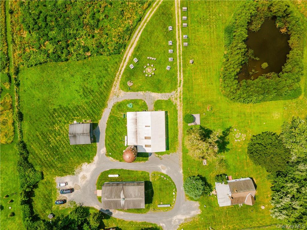 an aerial view of a residential houses with yard