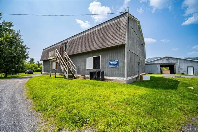 a front view of house with yard and trees