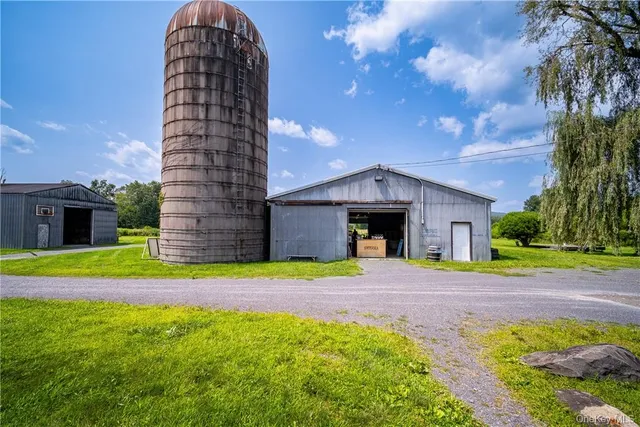 a view of a house with a yard and a garden