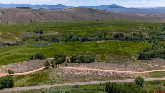 a view of a mountain with a yard
