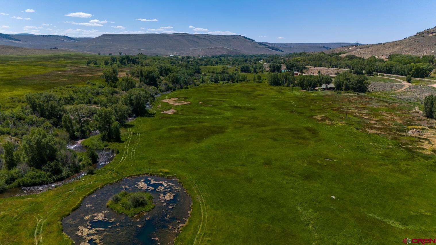 32 Bench Road Parlin, CO 81239 - Photo 17 of 34 a view of a lush green outdoor space with a swimming pool and valleys in the background