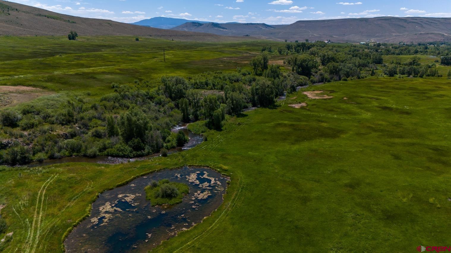 32 Bench Road Parlin, CO 81239 - Photo 6 of 34 a view of a lush green outdoor space with a swimming pool