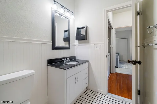 a bathroom with a sink toilet and mirror