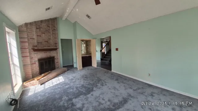 a view of empty room with a fireplace
