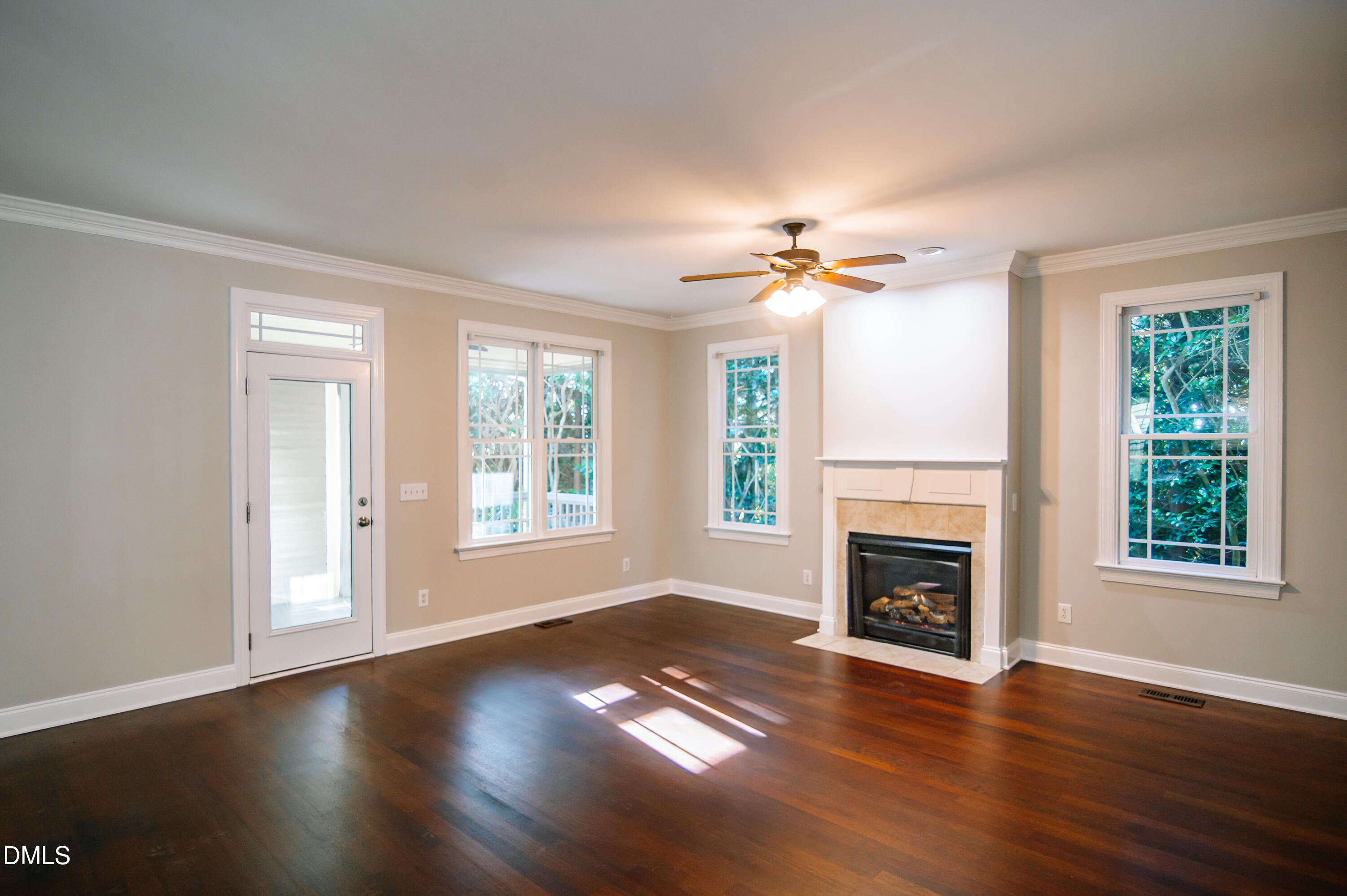 2106 Cloud Cover Lane Raleigh, NC 27614 - Photo 9 of 35 an empty room with windows fireplace and wooden floor