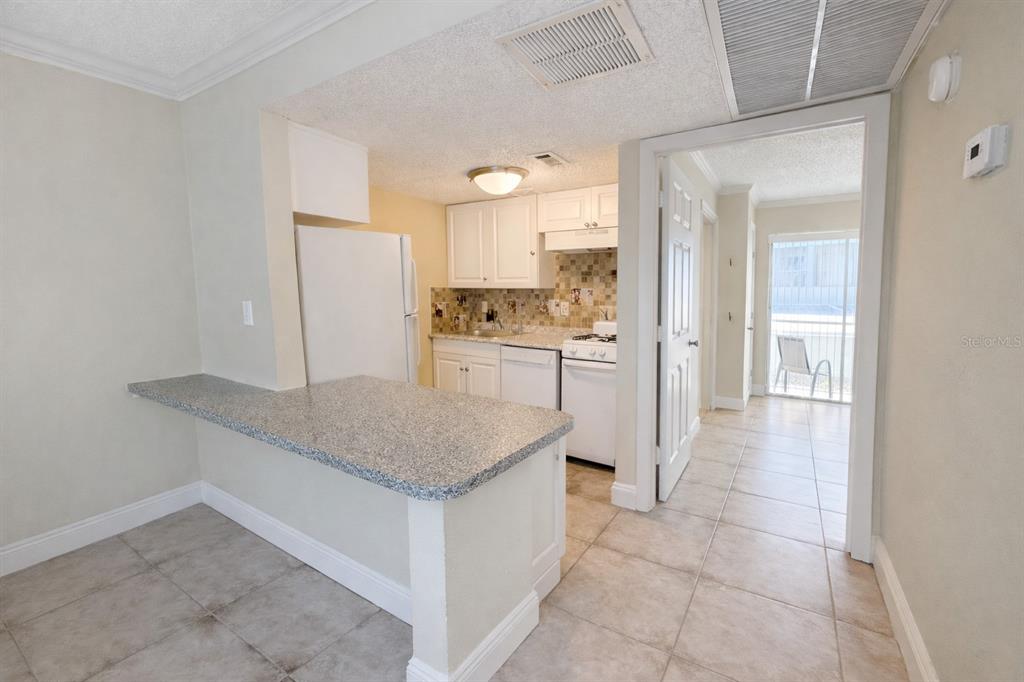 125 Water Front Way, Unit 110 Altamonte Springs, FL 32701 - Photo 6 of 17 a kitchen with stainless steel appliances granite countertop a sink and a refrigerator