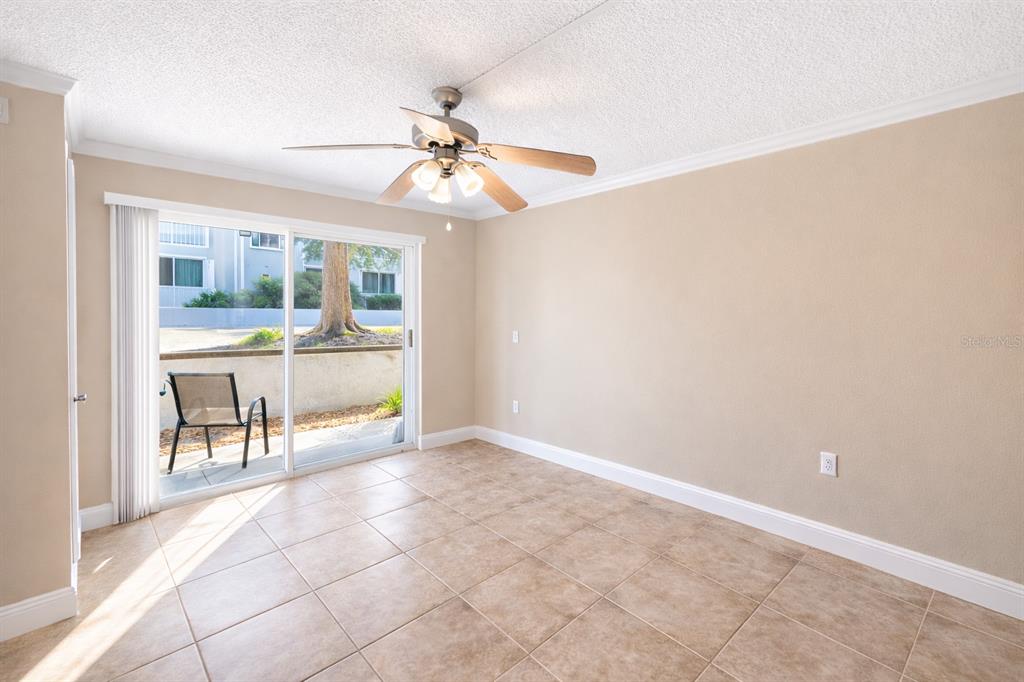125 Water Front Way, Unit 110 Altamonte Springs, FL 32701 - Photo 9 of 17 an empty room with chandelier fan and windows