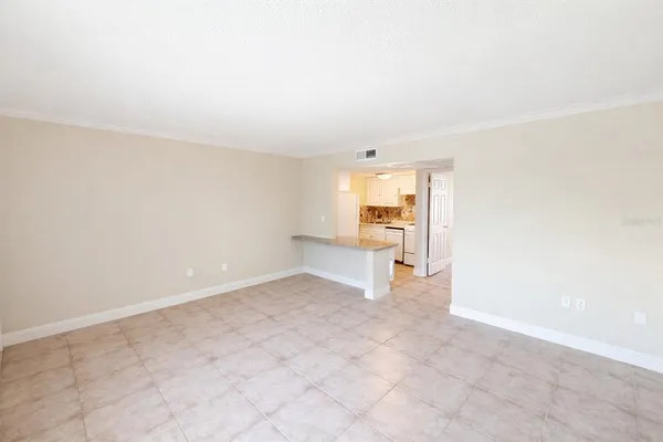 an empty room with a kitchen