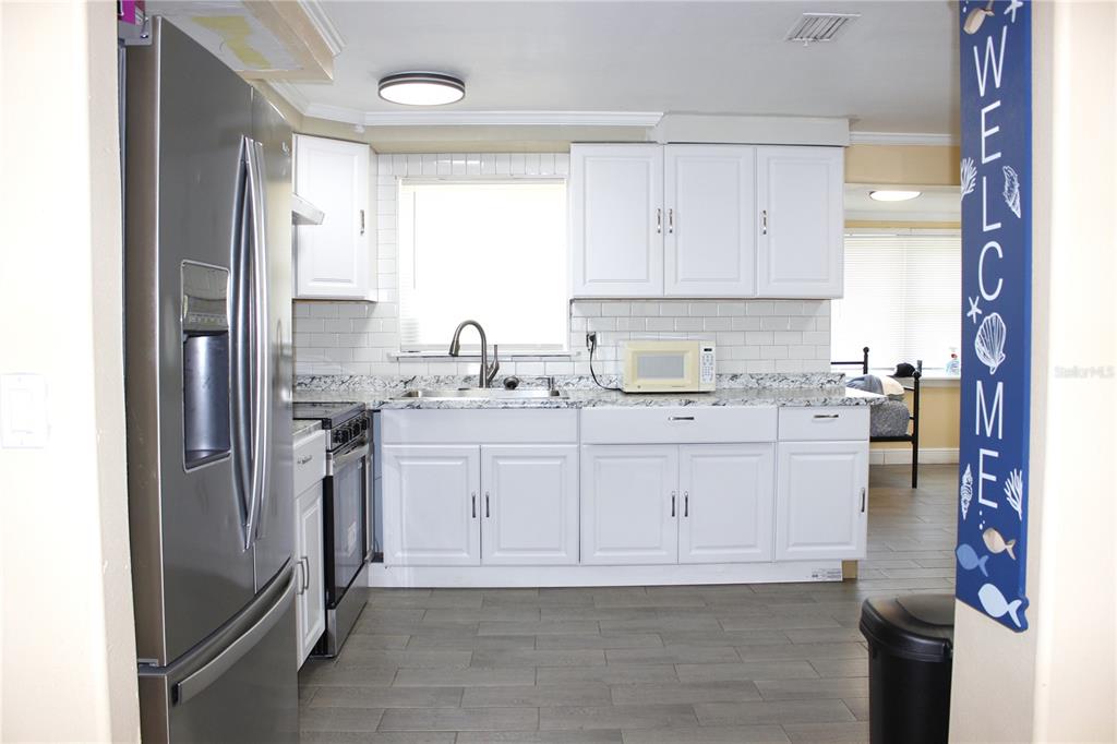 4550 Abdella Lane Holiday, FL 34690 - Photo 15 of 41 a kitchen with a sink cabinets and refrigerator
