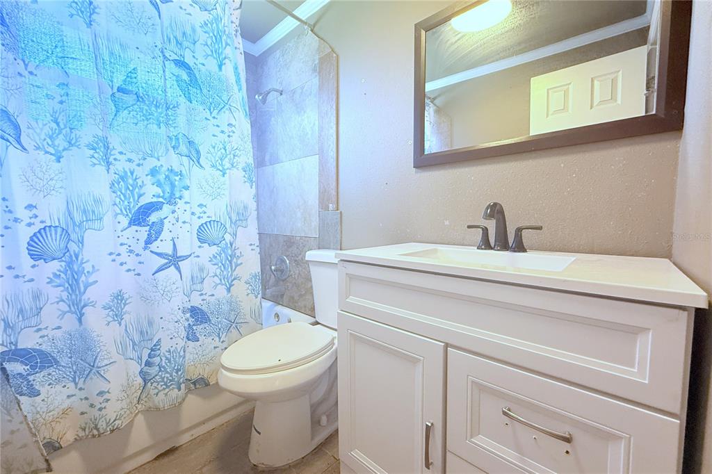 4550 Abdella Lane Holiday, FL 34690 - Photo 22 of 41 a bathroom with a toilet sink and mirror