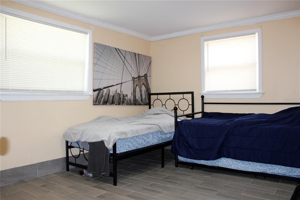 4550 Abdella Lane Holiday, FL 34690 - Photo 24 of 41 a bedroom with a bed window and a lamp