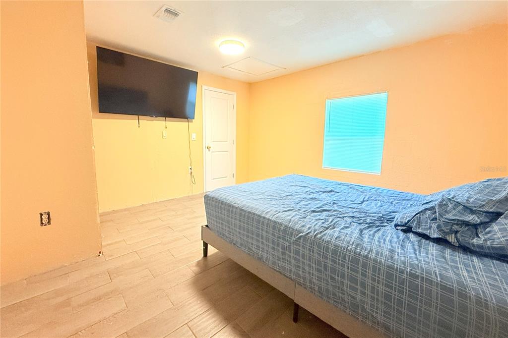 4550 Abdella Lane Holiday, FL 34690 - Photo 26 of 41 a bedroom with a bed and a flat screen tv