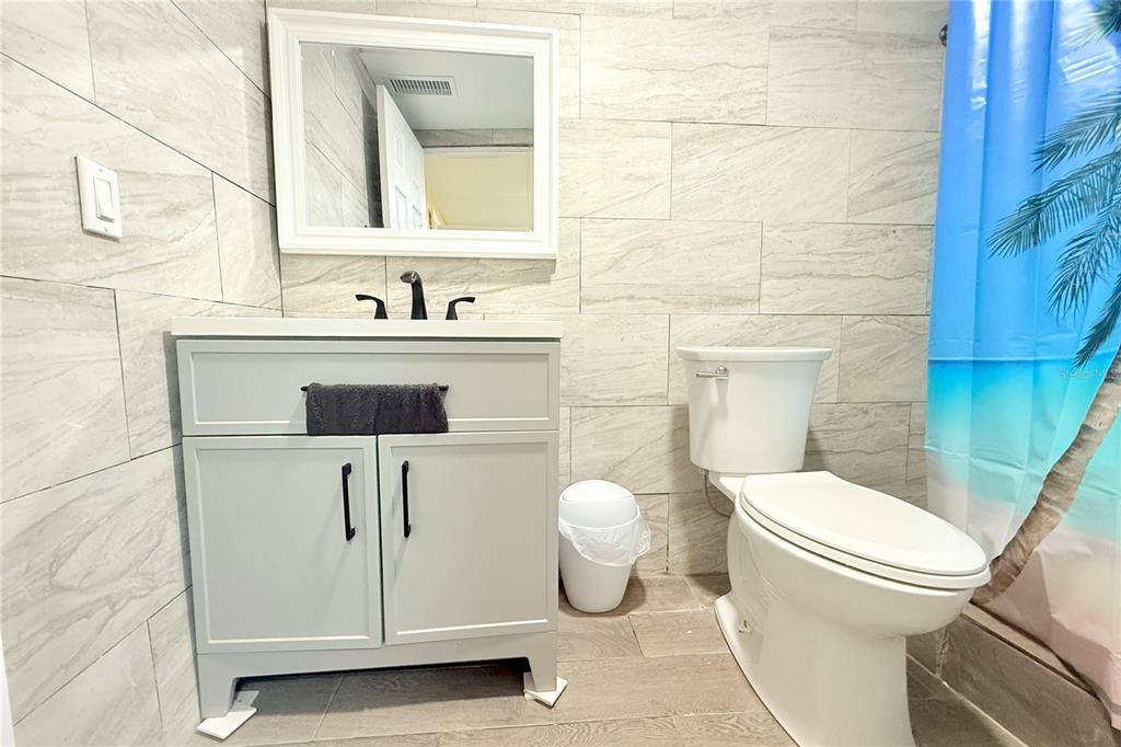 4550 Abdella Lane Holiday, FL 34690 - Photo 28 of 41 a bathroom with a toilet sink and mirror