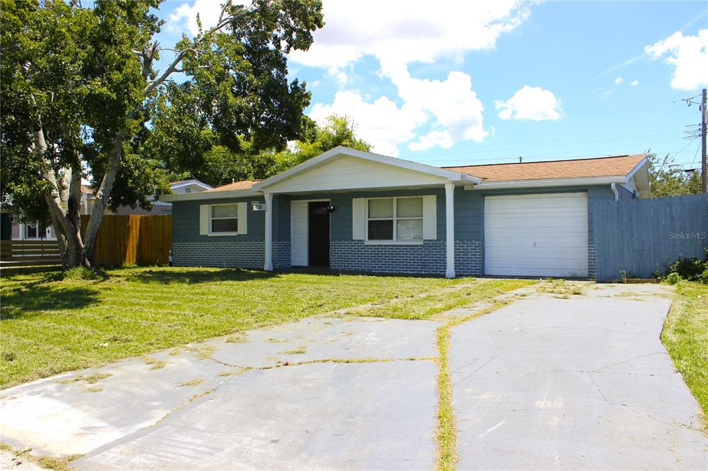 4550 Abdella Lane Holiday, FL 34690 - Photo 3 of 41 a front view of a house with a yard and garage