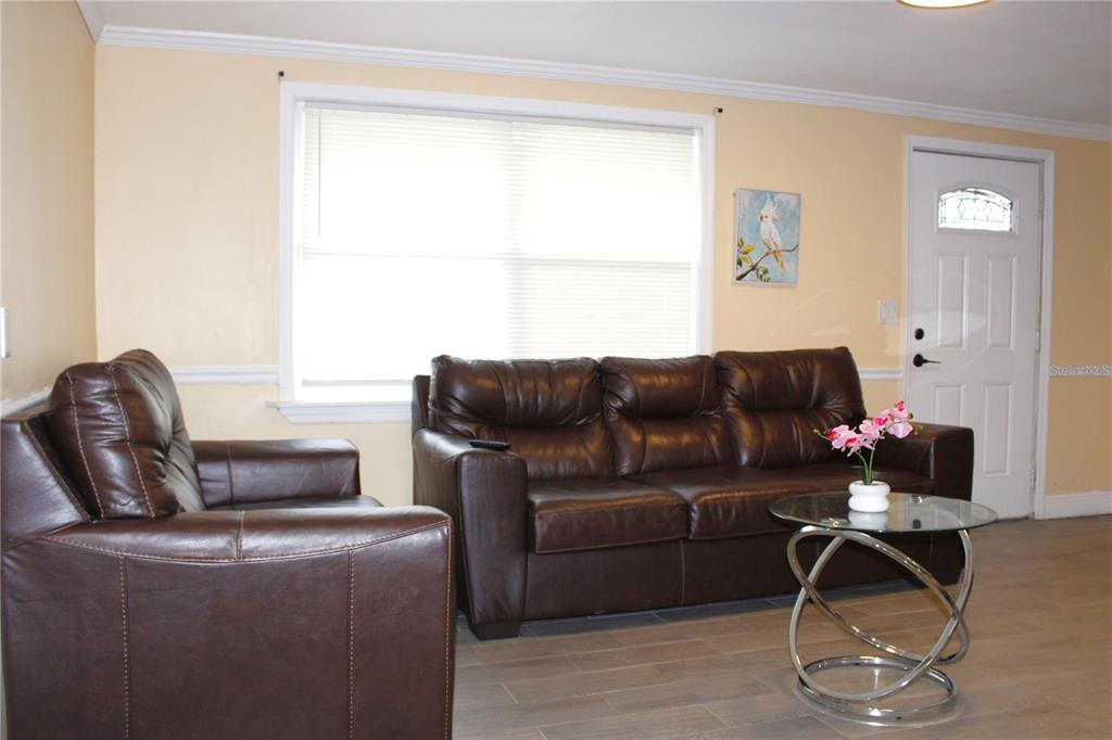 4550 Abdella Lane Holiday, FL 34690 - Photo 9 of 41 a living room with furniture a desk and chair with wooden floor