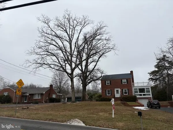 a front view of a building with trees