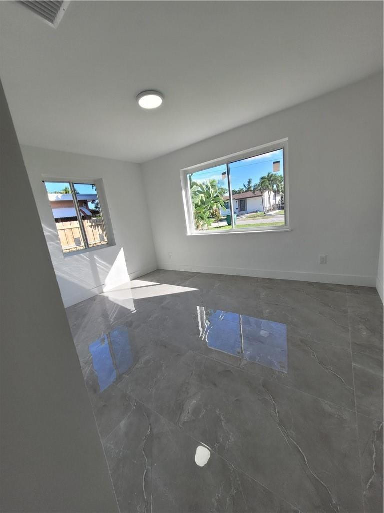 6041 Southwest 17th Street Miami, FL 33155 - Photo 18 of 26 an empty room with windows