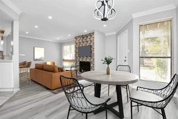 a living room with furniture a fireplace and a chandelier
