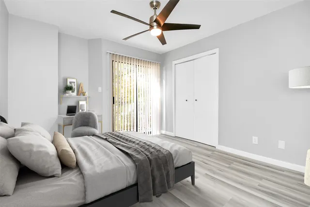 a bedroom with bed and a large window