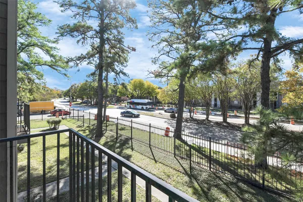 a view of a balcony with trees
