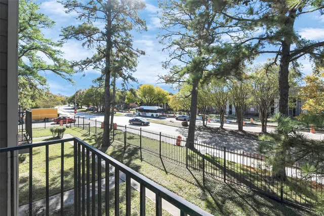 a view of a balcony with trees