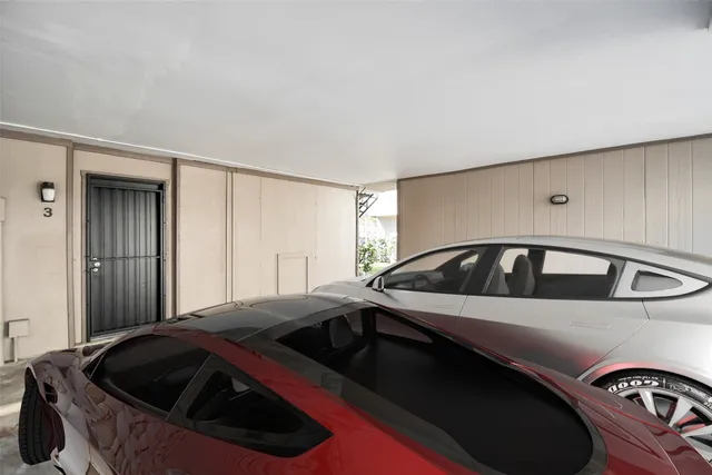 a view of a car park in front of a house