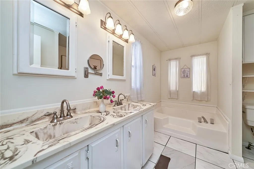17701 Avalon, Unit 372 Carson, CA 90745 - Photo 11 of 32 a bathroom with a sink and a mirror