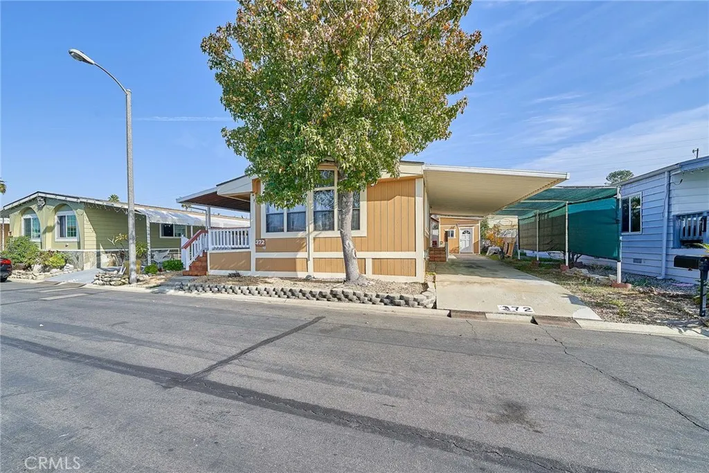 17701 Avalon, Unit 372 Carson, CA 90745 - Photo 2 of 32 a view of a house with a patio and a yard