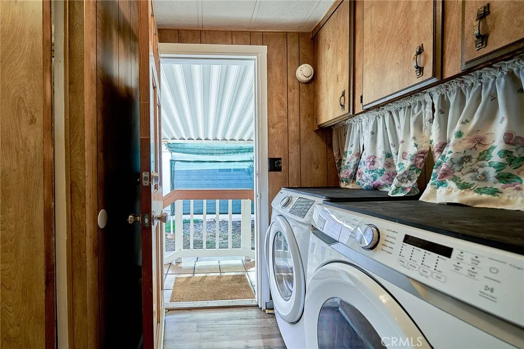 17701 Avalon, Unit 372 Carson, CA 90745 - Photo 21 of 32 a view of washer and dryer with wooden cabinet