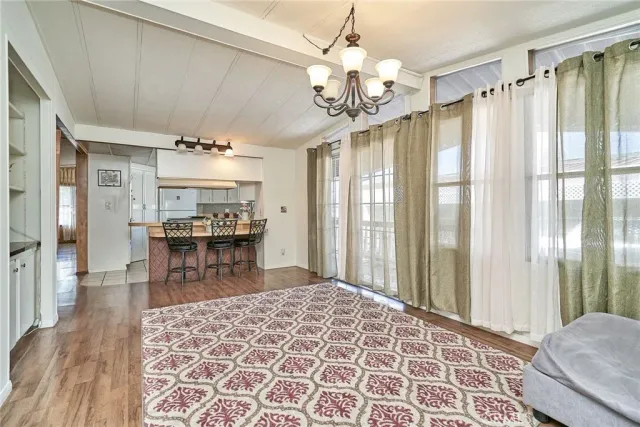 a large room with wooden floor and a chandelier