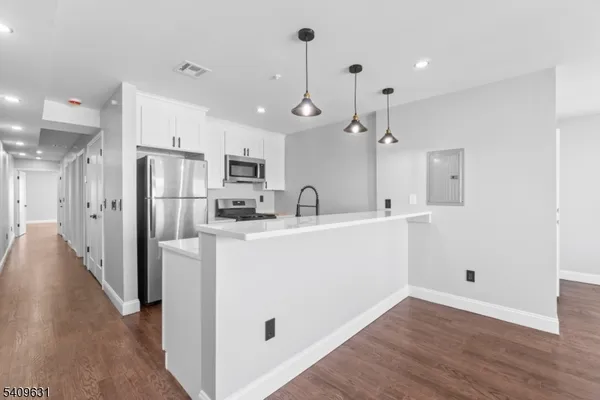 a view of a kitchen with electric appliances