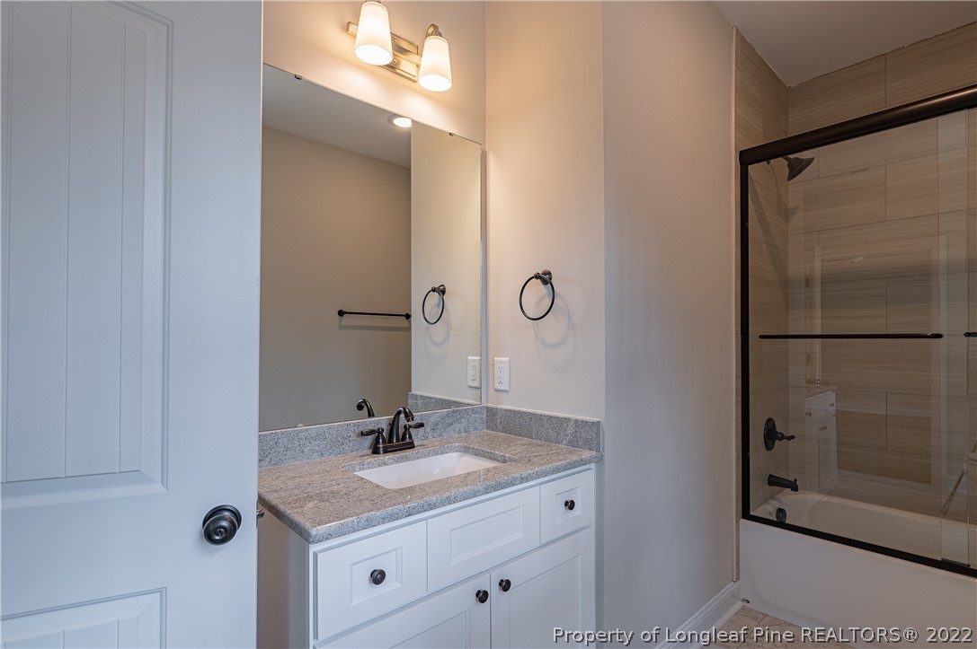 193 Kirk Road Aberdeen, NC 28315 - Photo 19 of 49 a bathroom with a sink and a mirror