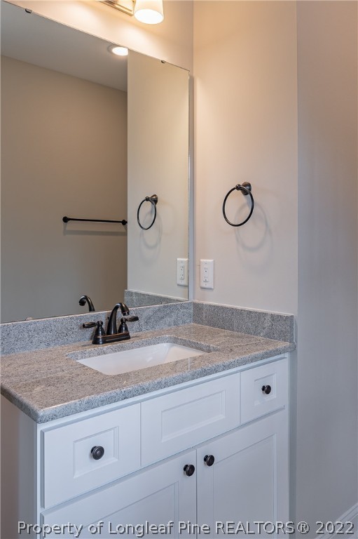193 Kirk Road Aberdeen, NC 28315 - Photo 26 of 49 a bathroom with a granite countertop sink and a mirror