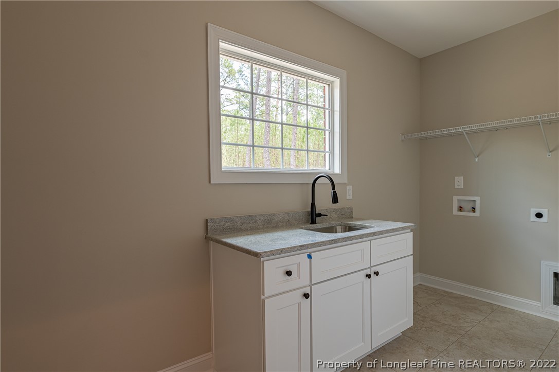 193 Kirk Road Aberdeen, NC 28315 - Photo 28 of 49 a kitchen with a sink cabinets and window