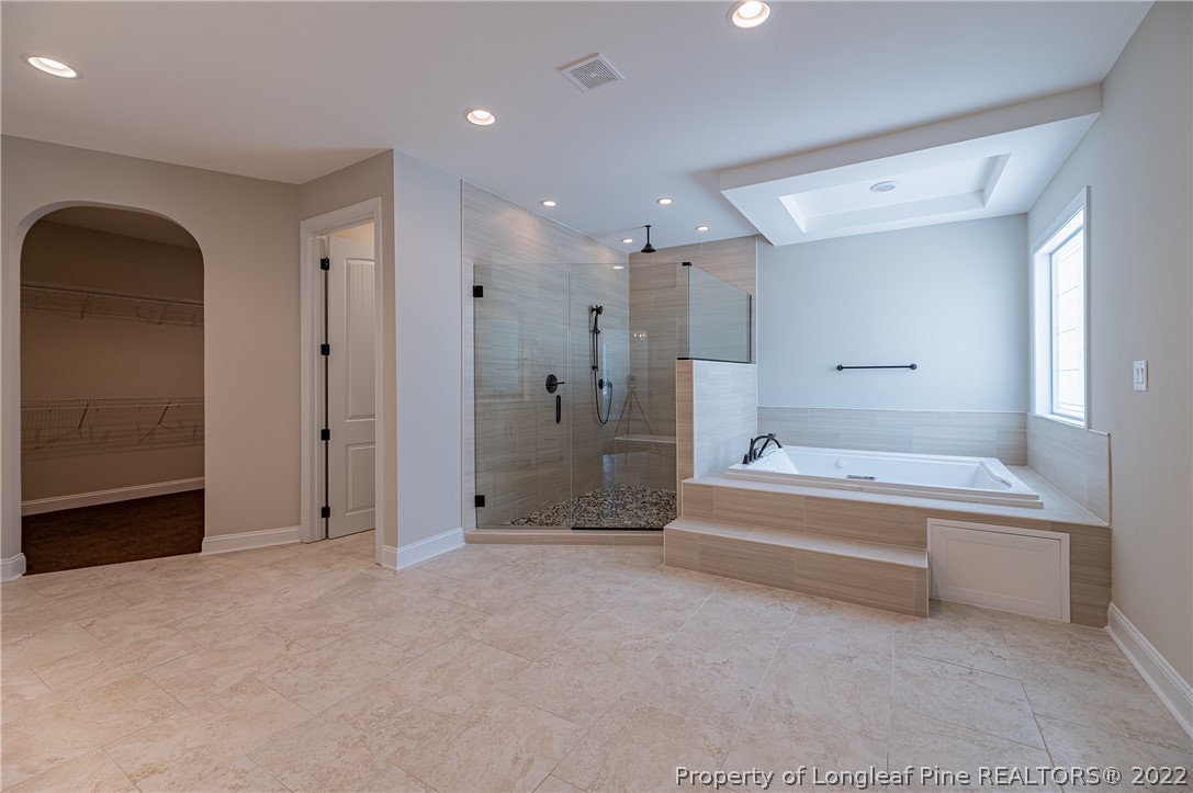 193 Kirk Road Aberdeen, NC 28315 - Photo 33 of 49 a spacious bathroom with a tub shower and mirror