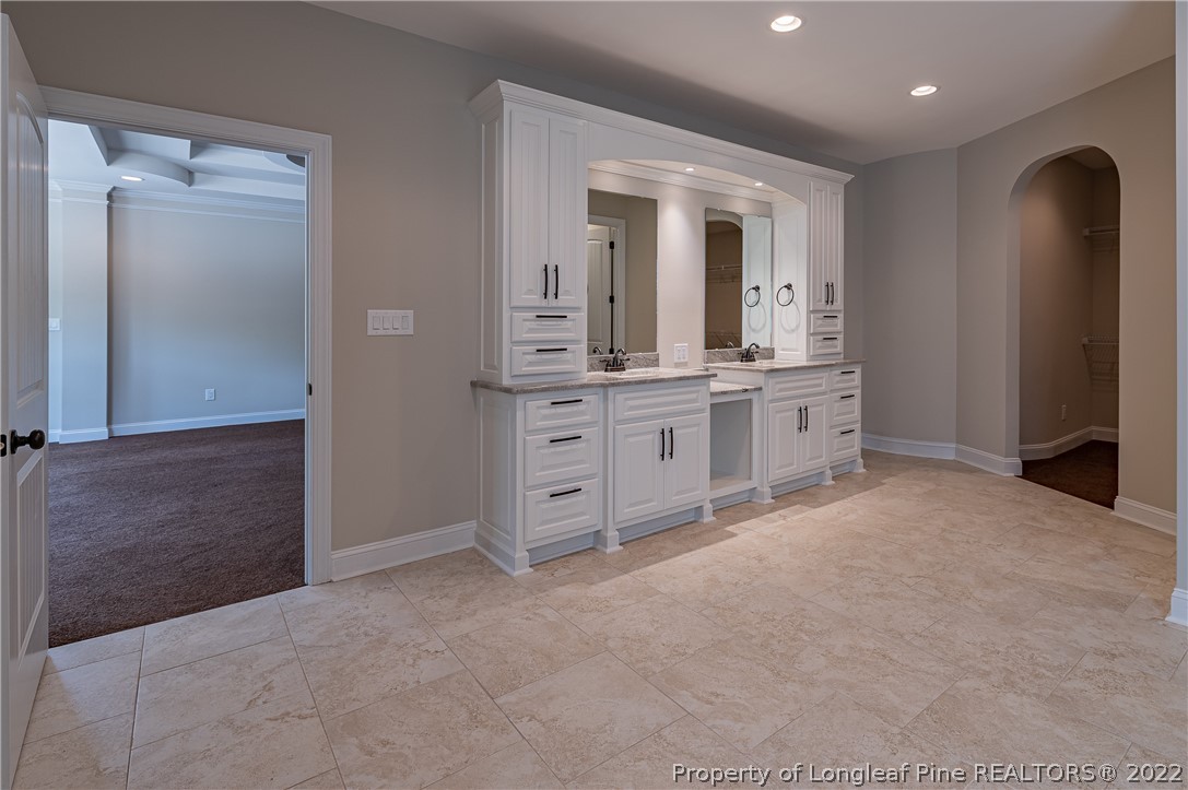 193 Kirk Road Aberdeen, NC 28315 - Photo 34 of 49 wooden floor with a bathroom and mirror
